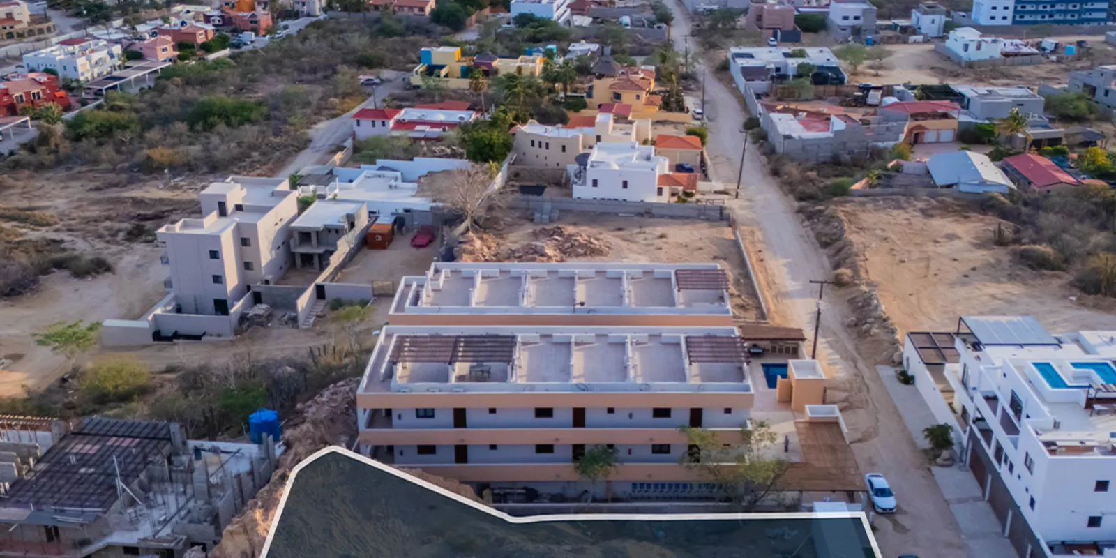 Aerial view of Los Cabos with El Arco landmark, showing the community where foreign buyers purchase property through a fideicomiso